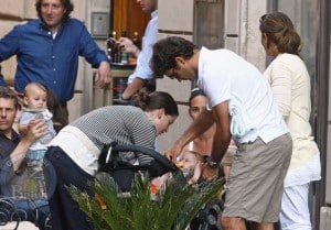 Roger and Mirka tuck one of their twins into their stroller