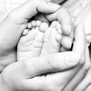 mom craddling baby's feet