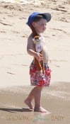 Coleen Rooneys' son Kai sports a monkey attached to his hat while at the beach