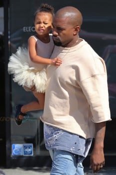 Kanye West carries his daughter North as they leave ballet class