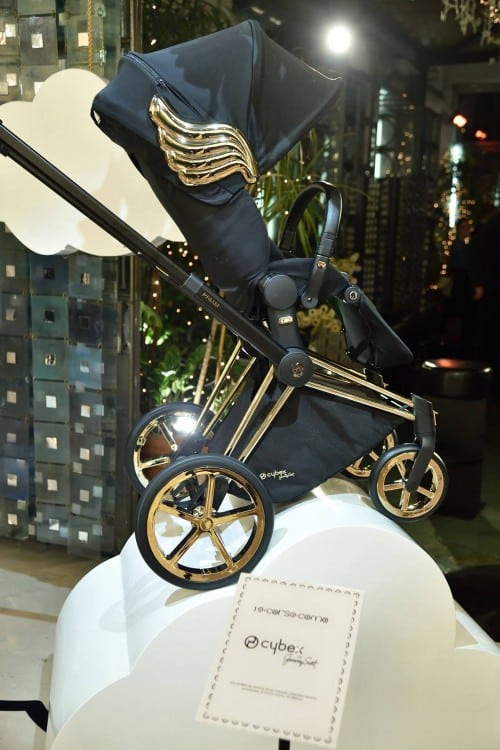 black stroller with gold wings