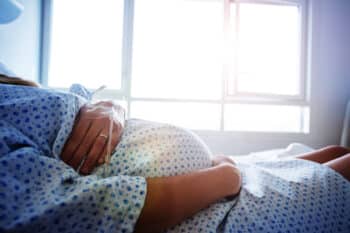 Close-up of a pregnant woman's belly in hospital