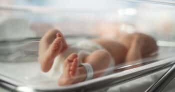 Newborn Baby Lying in Bassinet in a Maternity Hospital