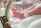 Newborn girl baby inside incubator in hospital