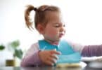 Little girl toddler picking her food