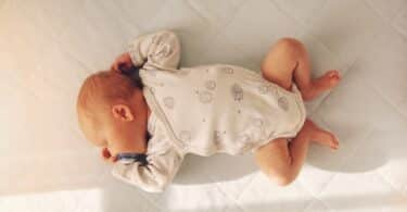 Newborn baby boy sleeping in a crib