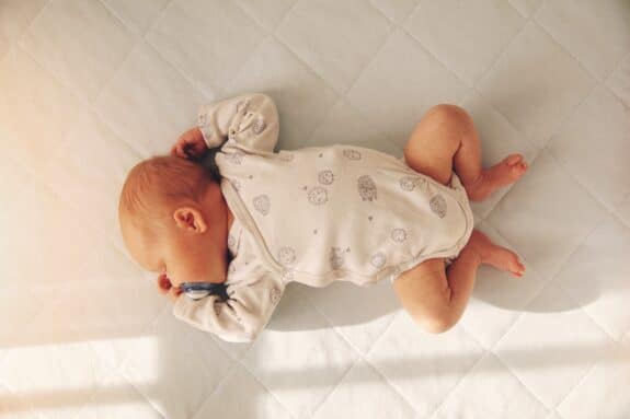 Newborn baby boy sleeping in a crib