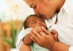 Newborn baby one-month-old holding fingers mothers hand