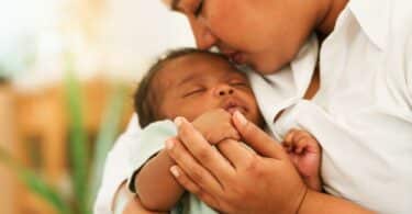 Newborn baby one-month-old holding fingers mothers hand