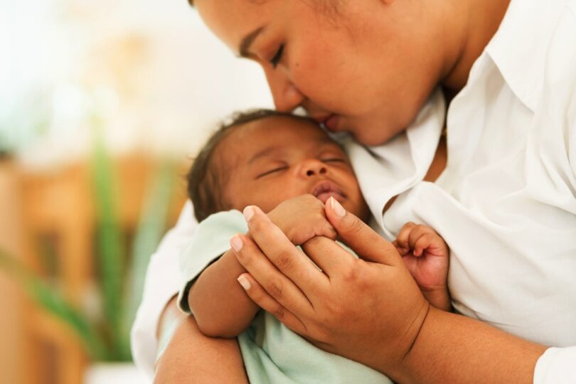 Newborn baby one-month-old holding fingers mothers hand