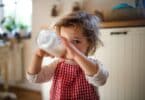 toddler drinking milk from a bottle