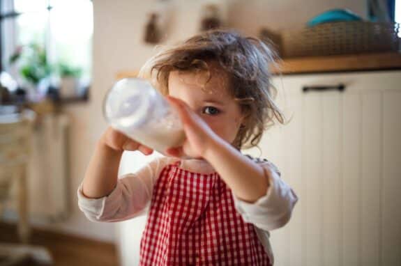 toddler drinking milk from a bottle