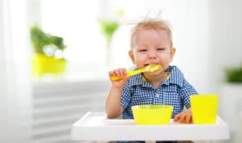 Happy baby eating himself