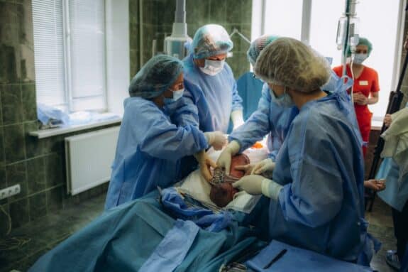 Baby being born via Caesarean Section