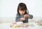 child playing with beads