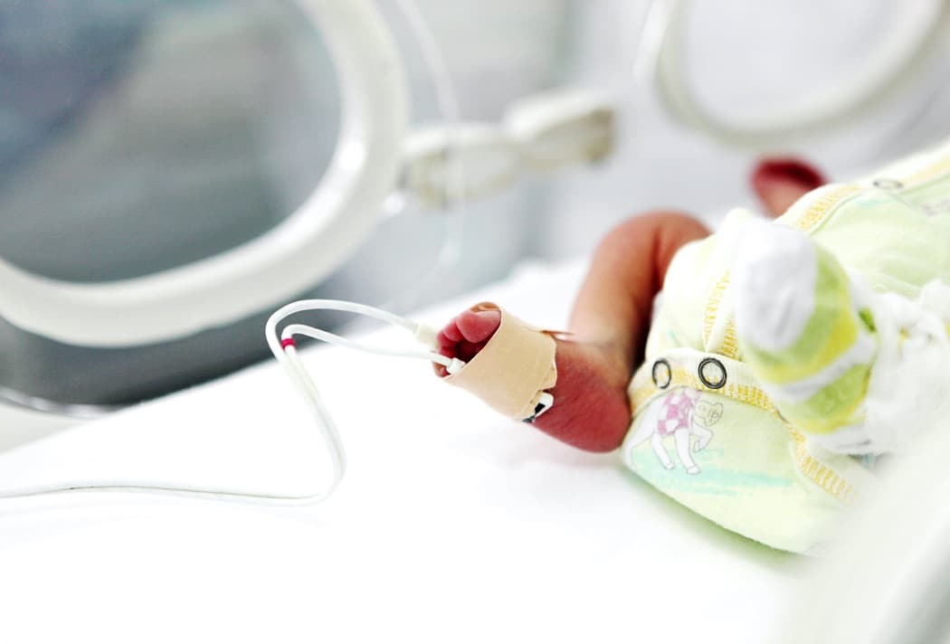 Newborn Baby Leg Wrapped With Device In Hospital