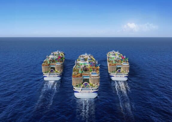 Three Icon class cruise ships sailing away in the ocean